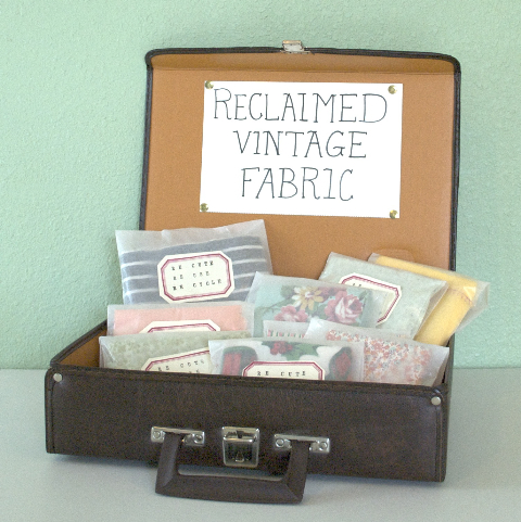 vintage fabric displayed in a suitcase